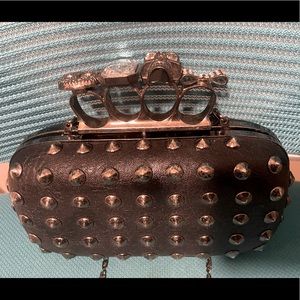 Cute brass knuckle purse.Black w silver accents and bling punk emo style studded